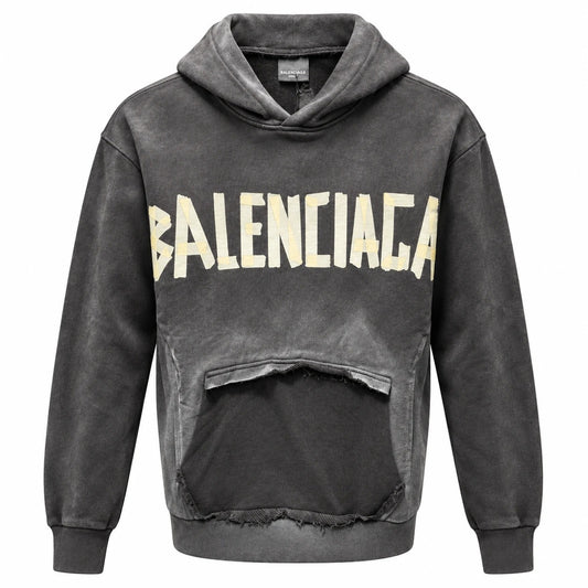Charcoal Balenciaga hoodie with ivory and pale yellow front lettering and a distressed pocket panel.