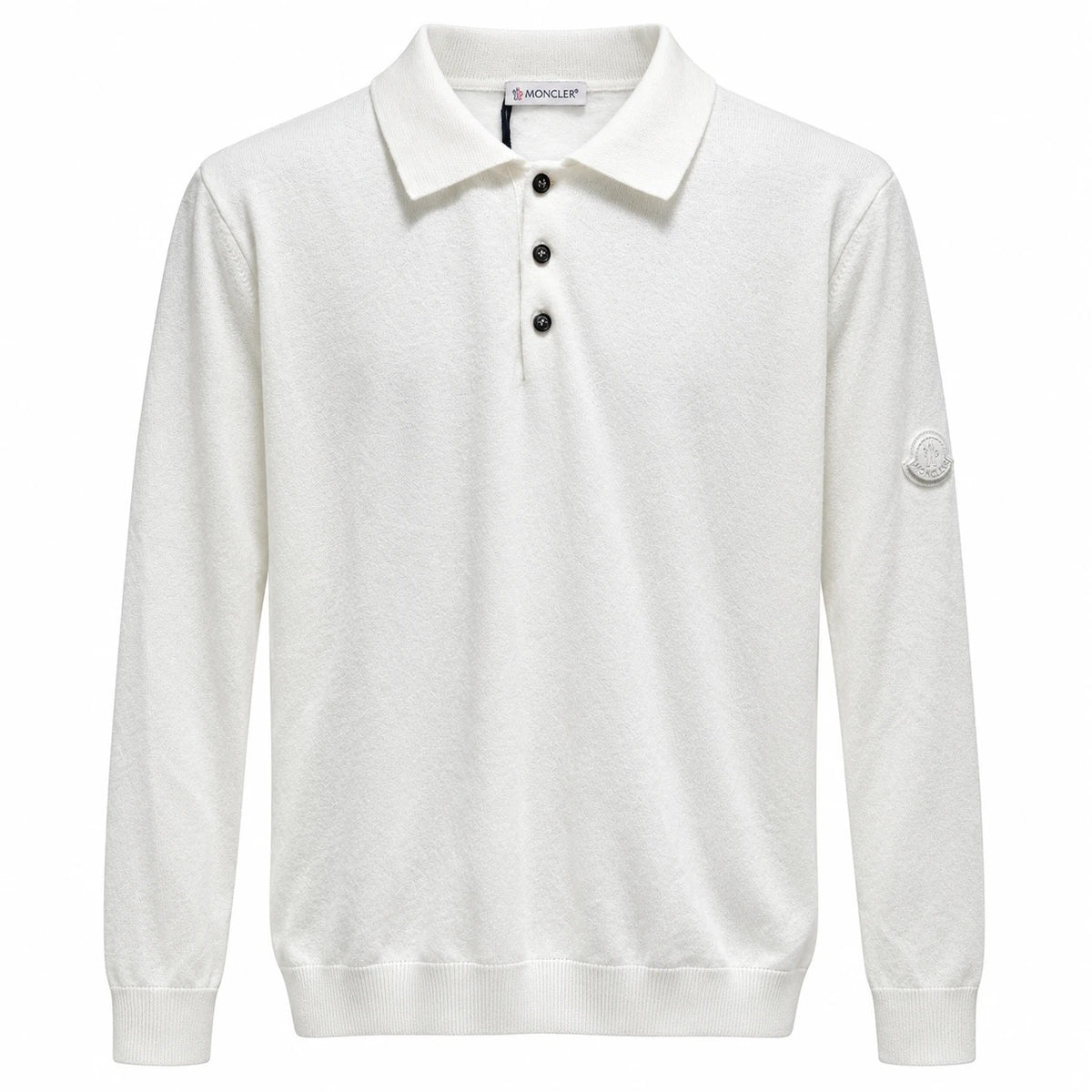 White Moncler long-sleeve knit polo with three black buttons and a tonal sleeve badge