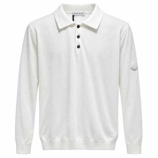 White Moncler long-sleeve knit polo with three black buttons and a tonal sleeve badge